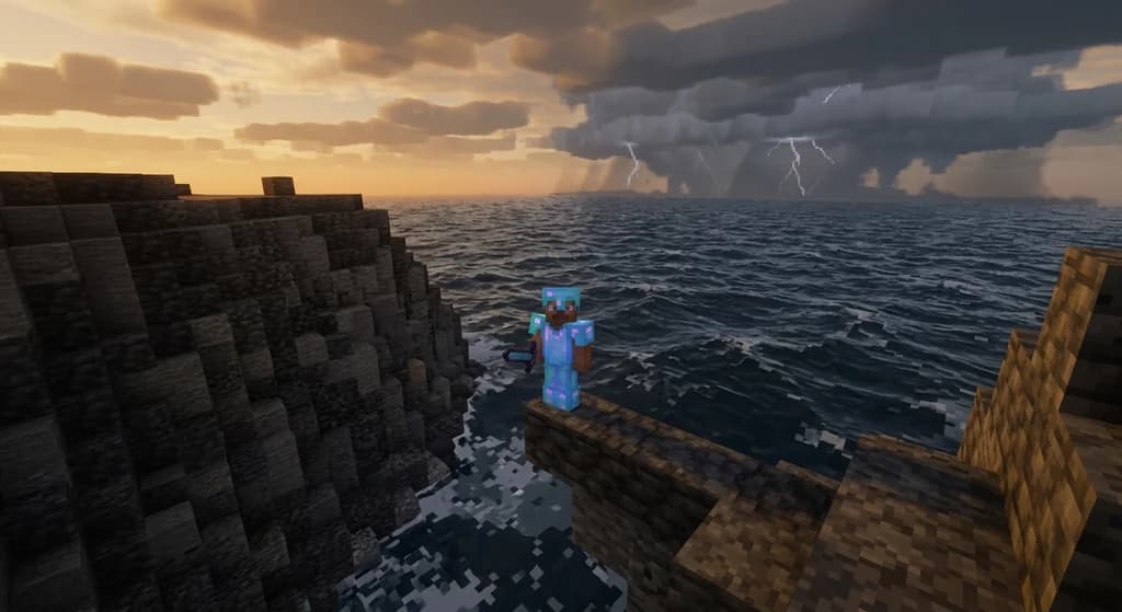 A player in diamond armor on a deepslate cliff edge overlooking a stormy ocean in a high-stakes Hardcore mode scene.