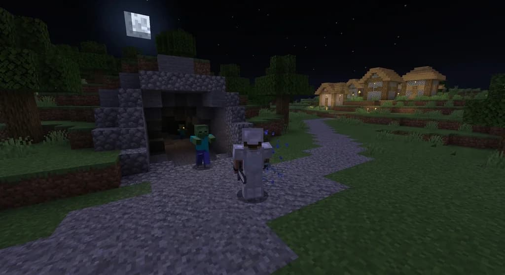 A Minecraft player facing a zombie at night near a cave entrance with low health.
